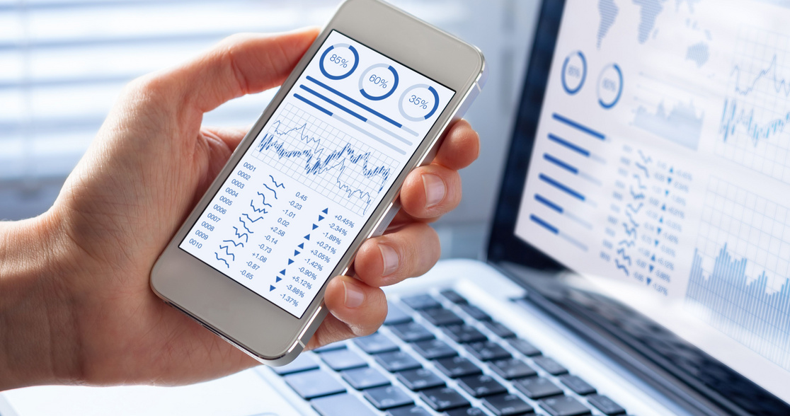 Investor analyzing stock market with financial dashboard on smartphone, computer